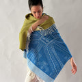 woman wearing shawl blue and moss green on white background