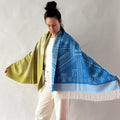 woman wearing shawl blue and moss green on white background