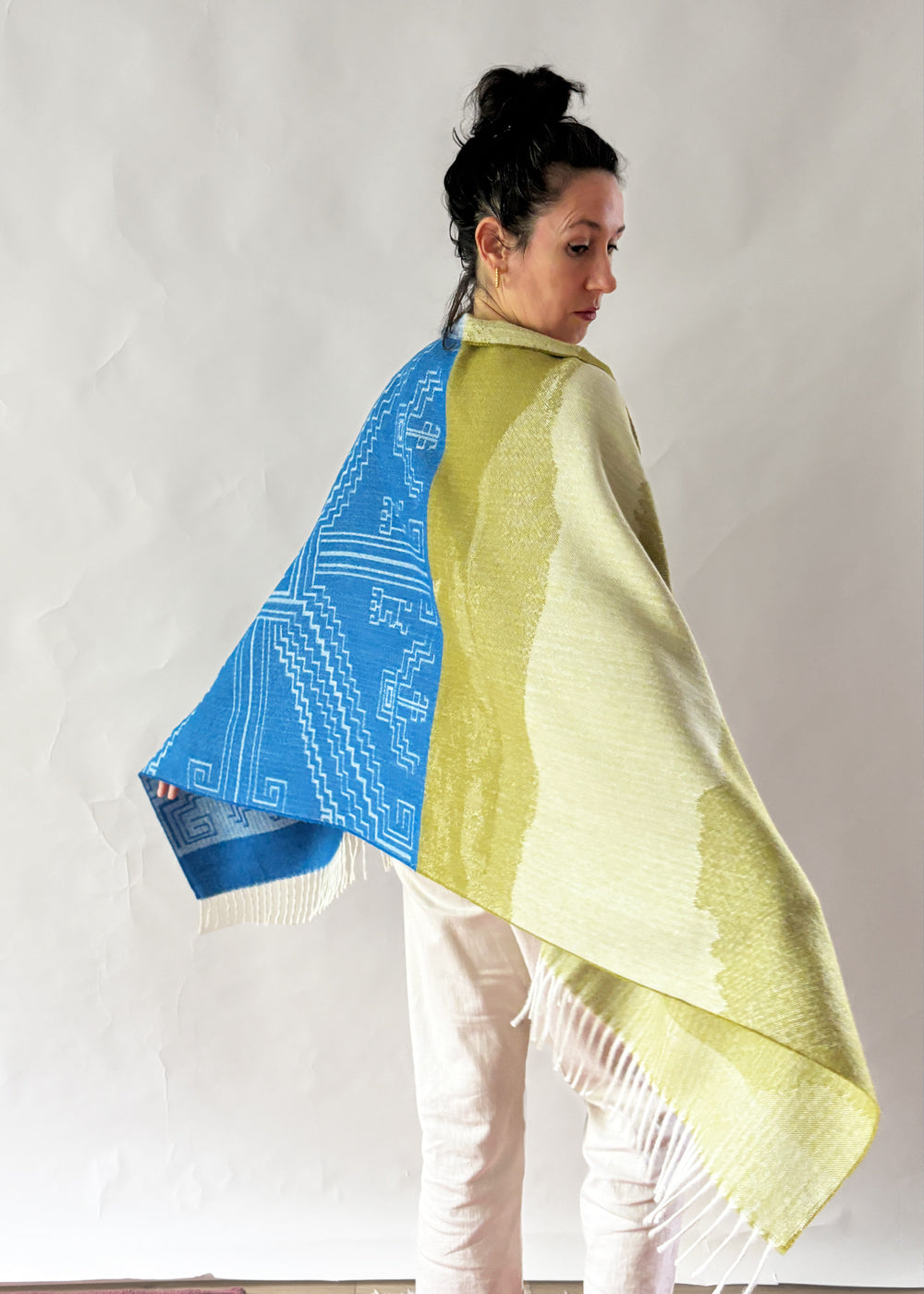 woman wearing shawl blue and moss green on white background